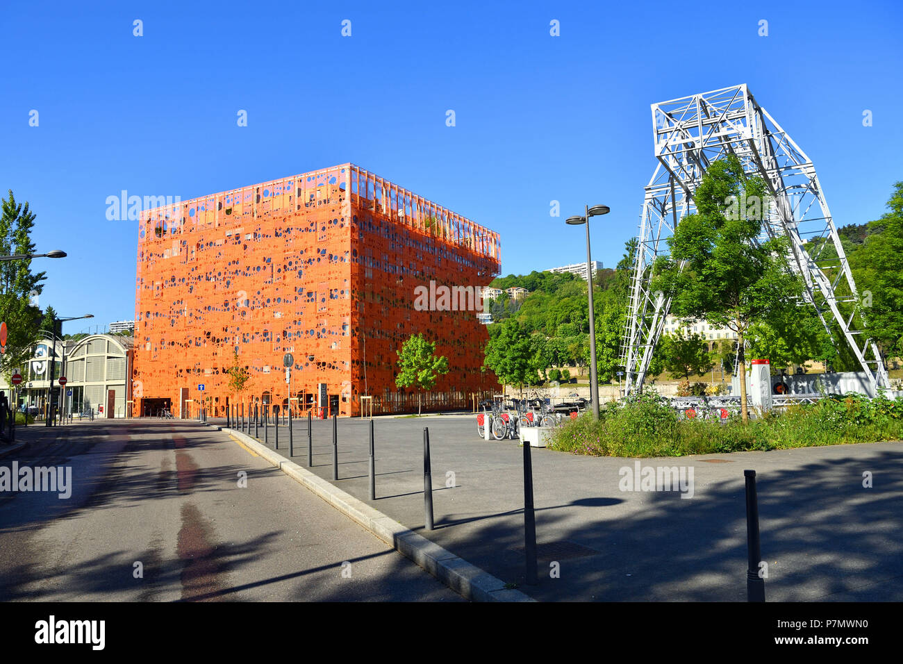 France, Rhone, Lyon, La Confluence district south of the Presqu'ile, close to the confluence of the Rhone and the Saone rivers, is the first French sustainable quarter certified by WWF, quai Rambaud and the Saone along the former docks, the Pavillon des Salins so called the Orange Cube of the architects Dominique Jakob and Brendan Mac Farlane Stock Photo