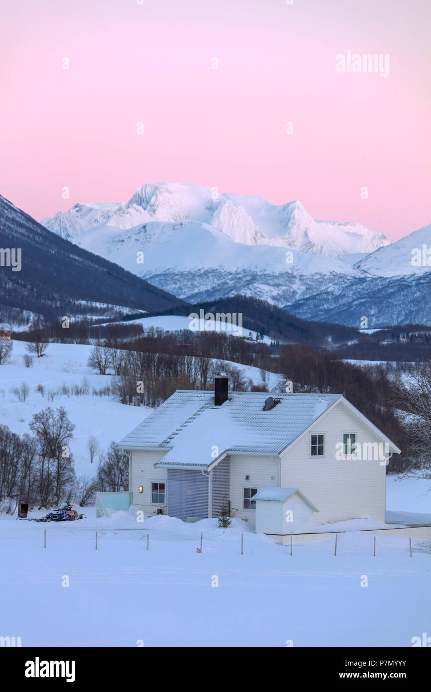 Sunrise on typical house with Lyngen Alps in the background, Mestervik, Troms county, Norway Stock Photo