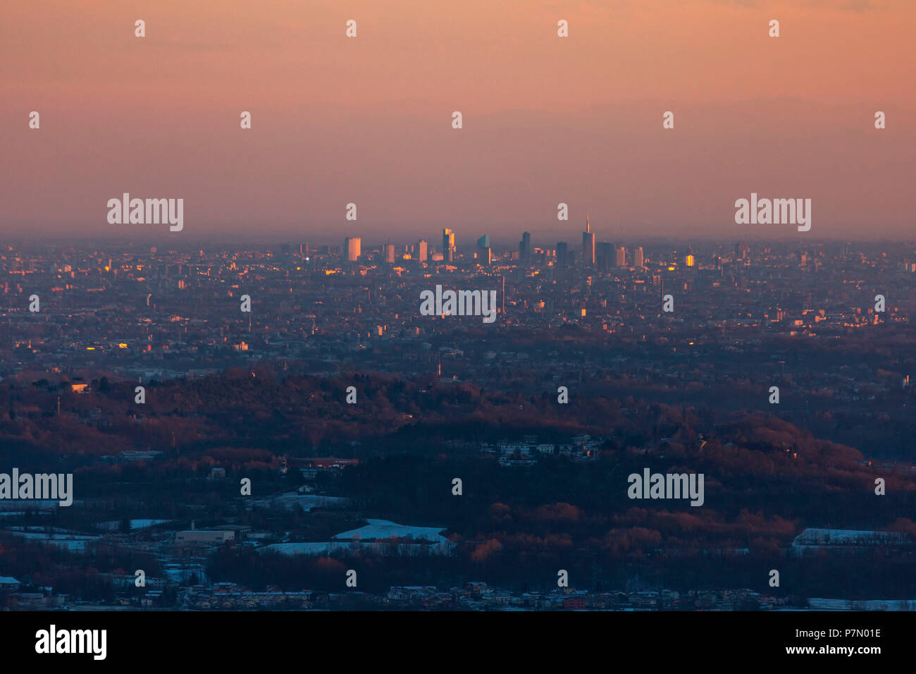 Milan skyline at sunset from the hills above Como, Como, Lombardy, Italy Stock Photo