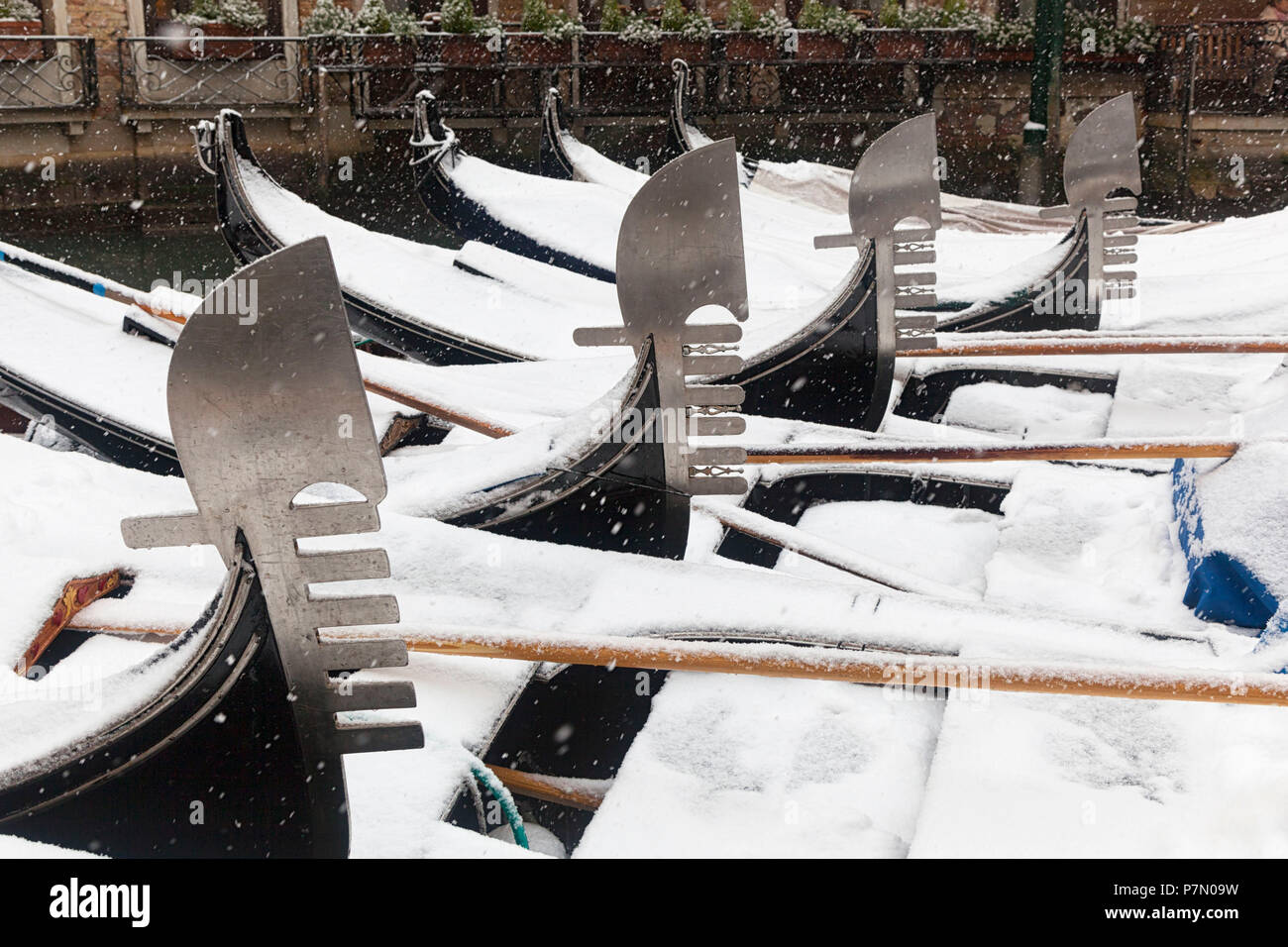 Bow irons' of venetian traditional gondolas during a snowfall, Orseolo Dock, Venice, Veneto, Italy Stock Photo