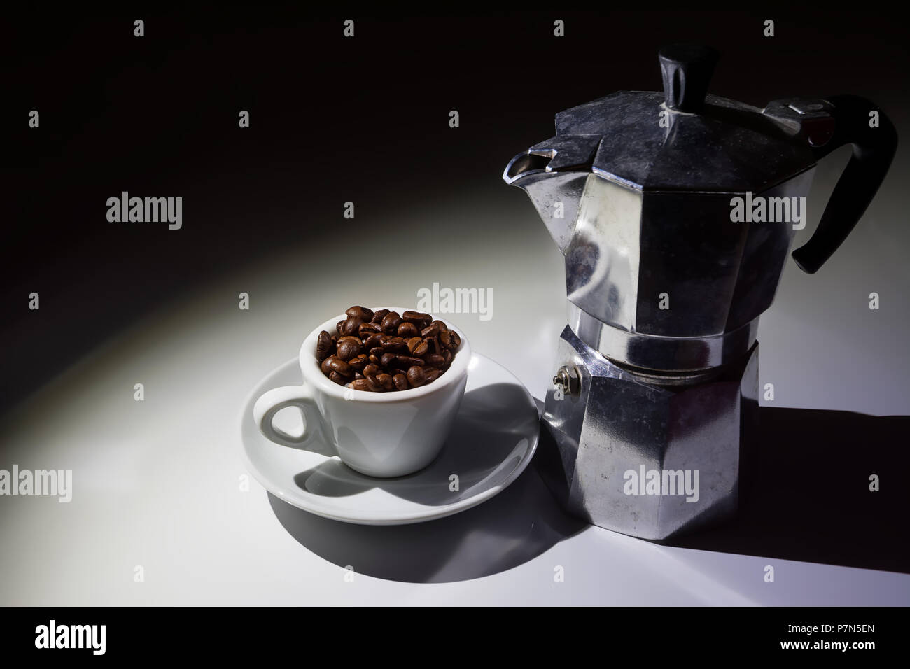 coffee cup full of roasted coffee beans and moka coffee pot Stock Photo