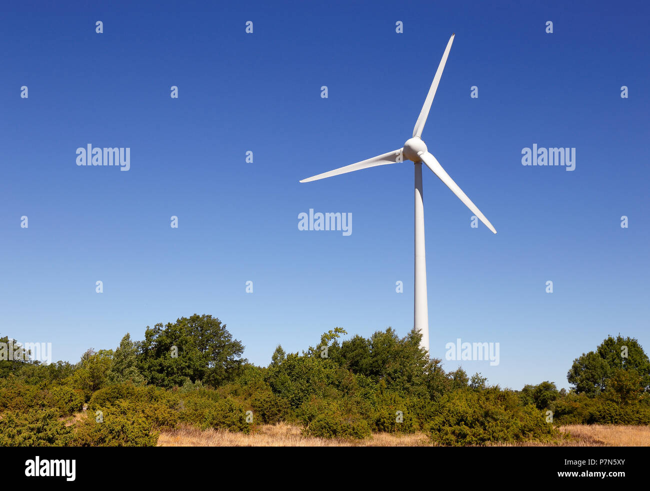 Wind turbine against a blue sky Stock Photo - Alamy