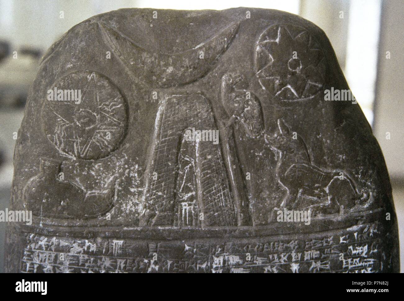 Mesopotamia. Stela of Babylonian origin with the representation of the sun, the moon and water with cuneiform writing in the lower part. 3.000 BC. Detail. Archaeological Museum of Iran. Theran. Stock Photo