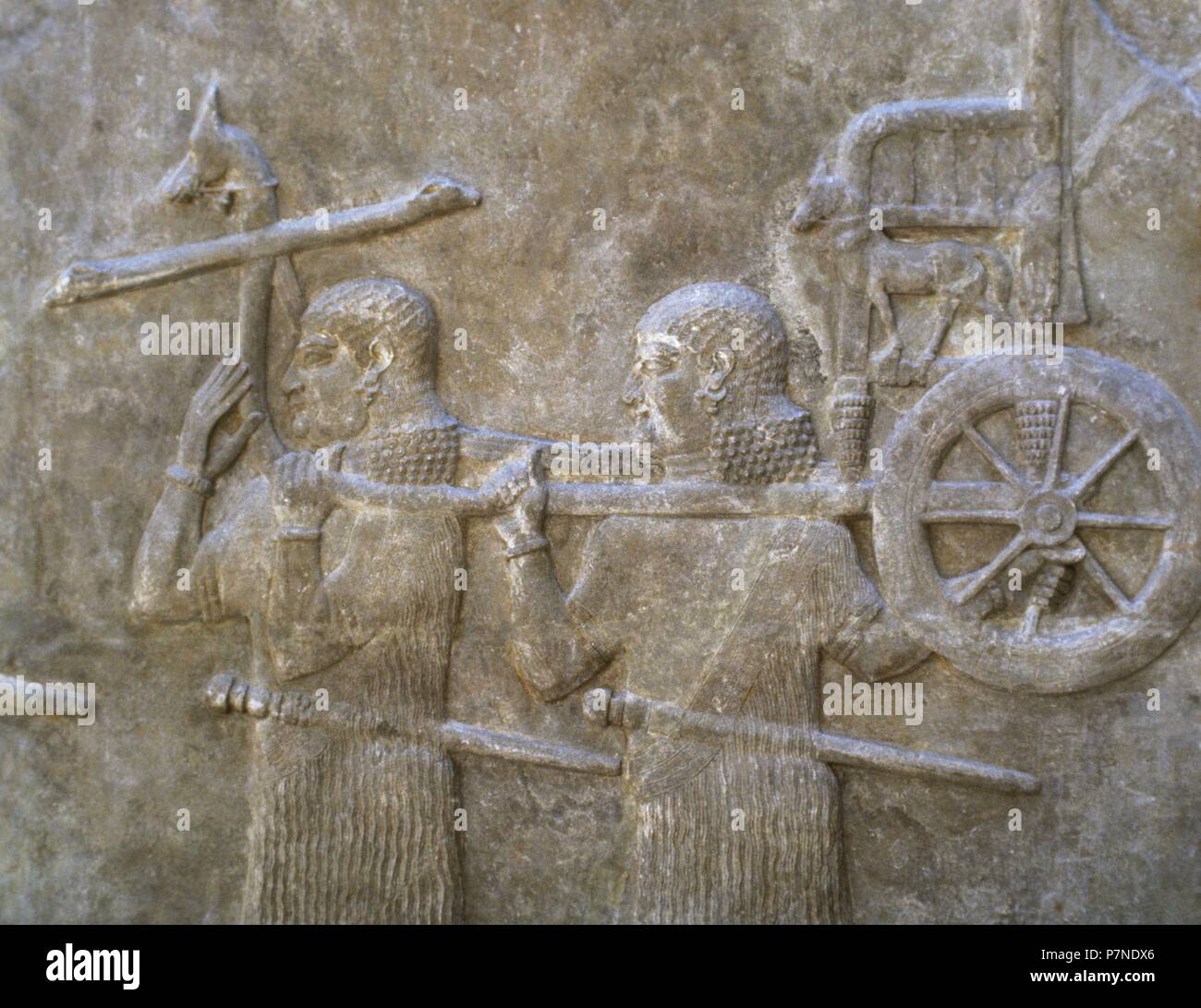 Servants transporting Sargon's chariot. 8th century BC. Relief. Palace of Sargon II of Assyria. Khorsabad, Iraq. Louvre Museum. Paris, France. Stock Photo