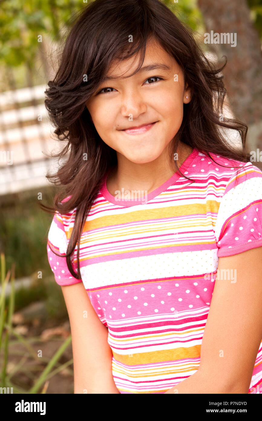 Portrait of a cute little girl smiling outside Stock Photo - Alamy
