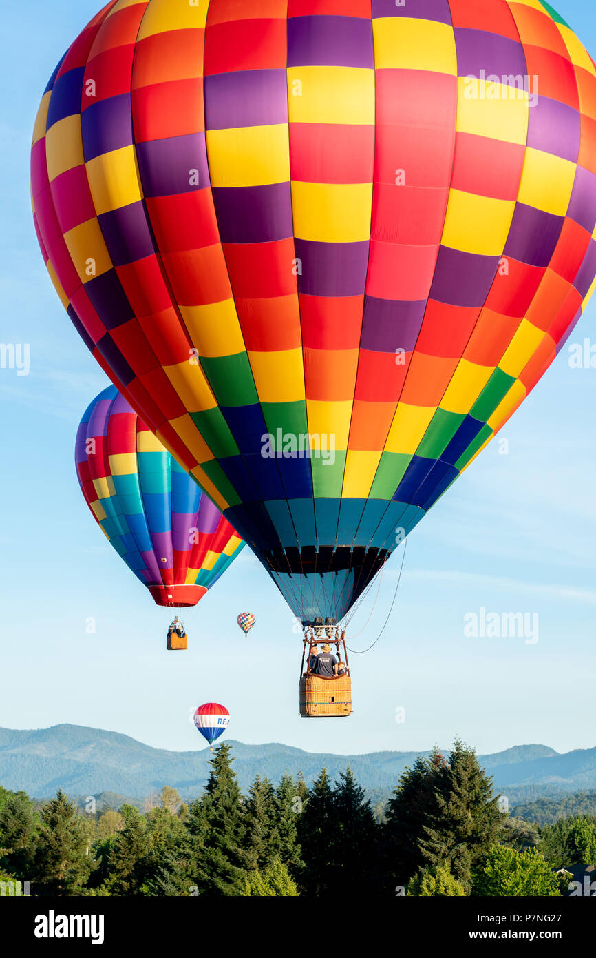 Hot Air Balloon Festival Grants Pass Oregon Hot air balloons soaring over fields and mountains during the Balloon & Kite Festival in Grants Pass Oregon Stock Photo - Alamy