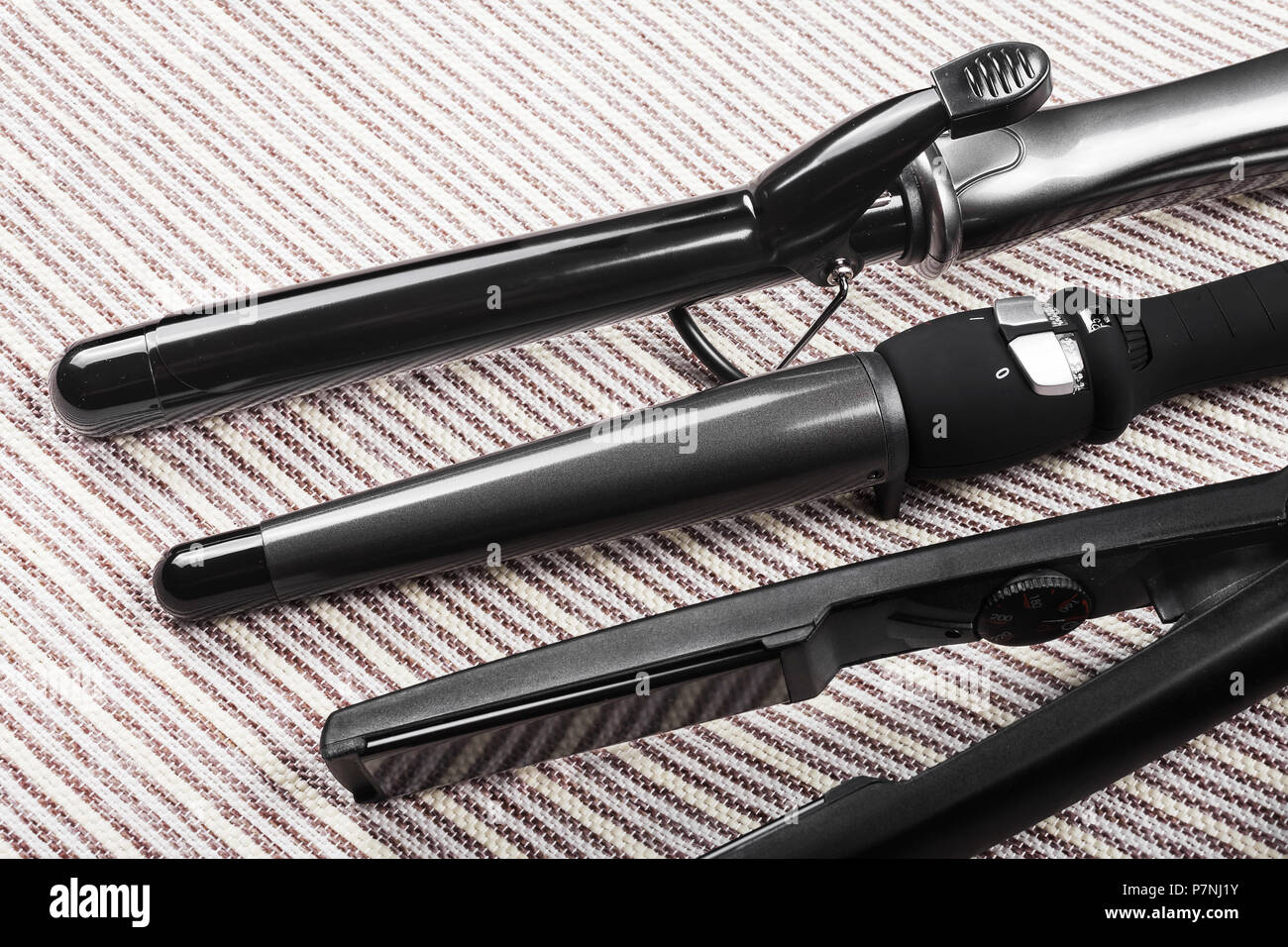 row of various hair straightening tools Stock Photo Alamy