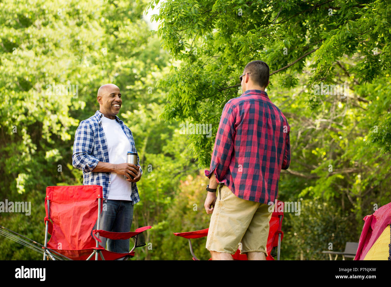 Friends talking and camping. Stock Photo