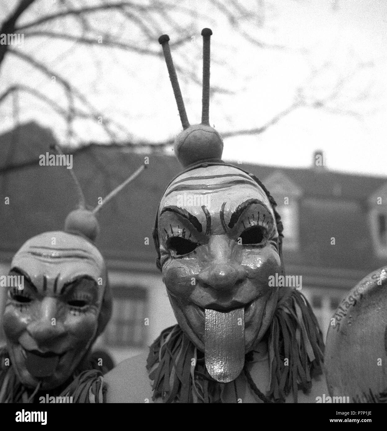 Men with mask stick their tongues out, carnival, around 1950, Freiburg, Germany Stock Photo