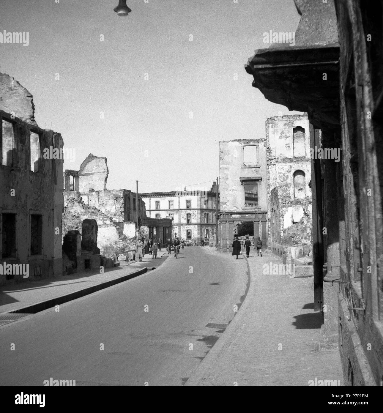 A street along destroyed buildings in Freiburg, ca. 1945, Freiburg, Germany Stock Photo