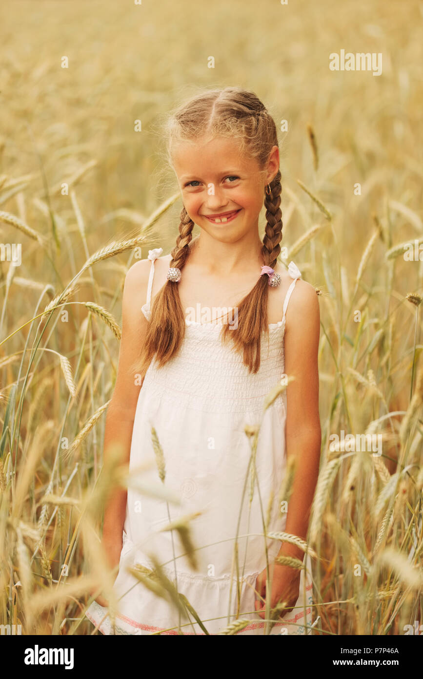 young girl in the yellow field Stock Photo - Alamy
