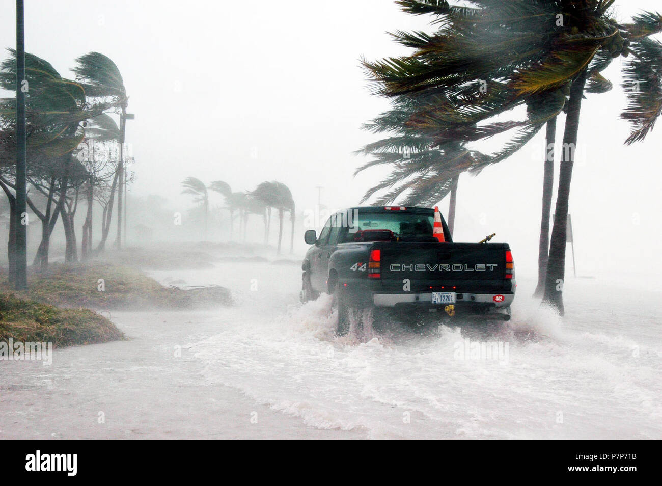 Navy. A US Navy (USN) security team eases their way through water and debris at Naval Air Station (NAS) Key West Truman Annex as Hurricane Dennis passes the southernmost tip of the base Saturday morning. The storm passed within 125 miles of the base, clocking winds in excess of 90 miles an hour and dumping more than seven inches of rain before moving north through the Gulf of Mexico. Stock Photo