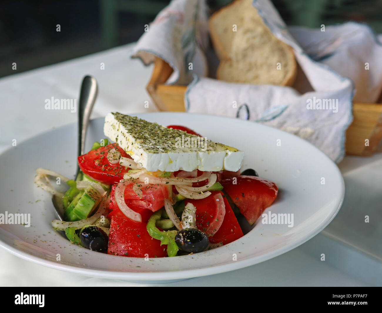 close up of greek salad with fresh tomatos, onions, feta cheese and black olives Stock Photo