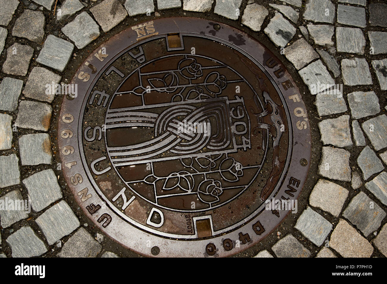 Roses and tower shown on manhole cover in Ålesund. Stock Photo