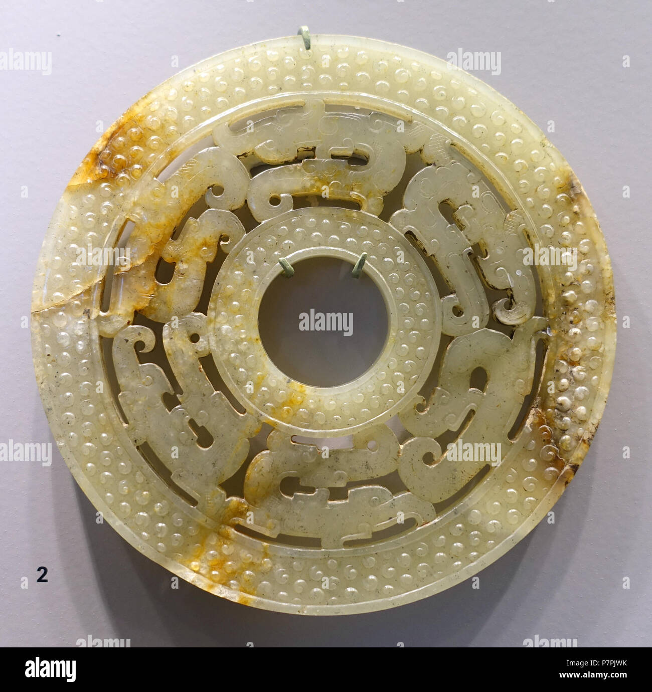 English: Exhibit in the Arthur M. Sackler Museum, Harvard University, Cambridge, Massachusetts, USA. This artwork is in the  because the artist died more than 70 years ago. 11 April 2015, 10:42:35 295 Ornate disk in openwork, China, Warring States period, 4th-3rd century BC, nephrite - Arthur M. Sackler Museum, Harvard University - DSC00749 Stock Photo