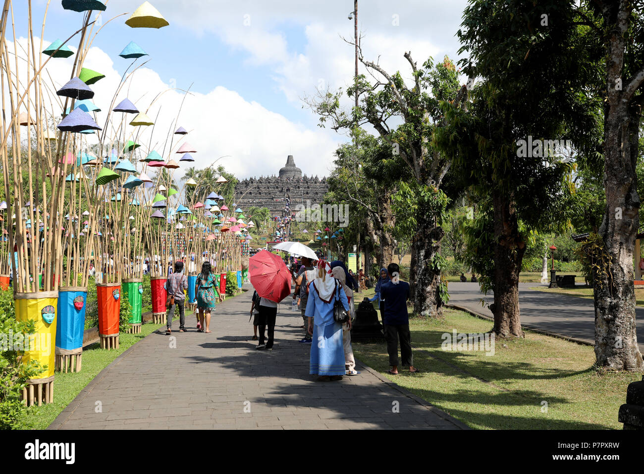 Borobudur, Indonesia – June 23 2018: Tourists walk towards the Buddhist temple of Borobudur, close to the city of Yogyakarta. Stock Photo