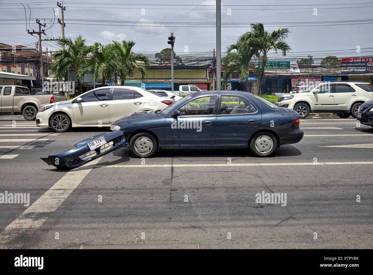Road accident. Car with the front bumper ripped off following a