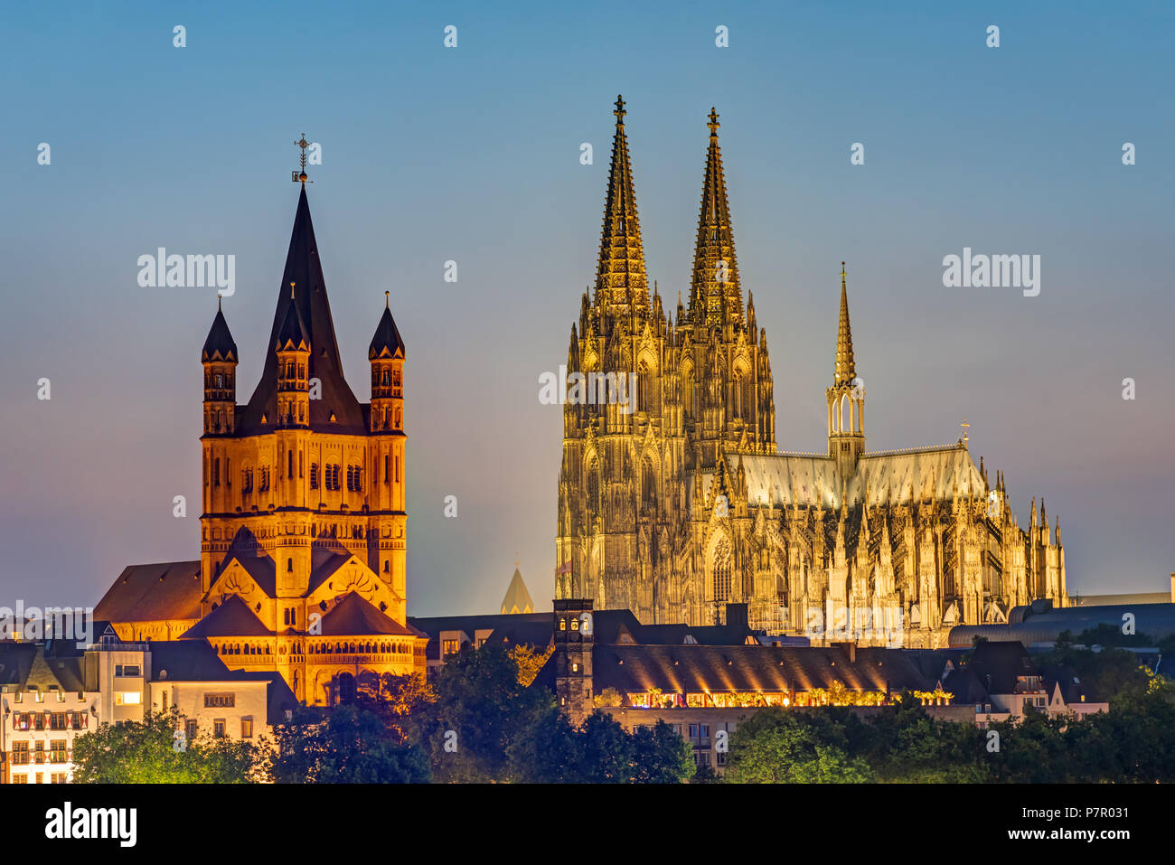 The famous cathedral and Great St. Martin Church in Cologne at dusk Stock Photo