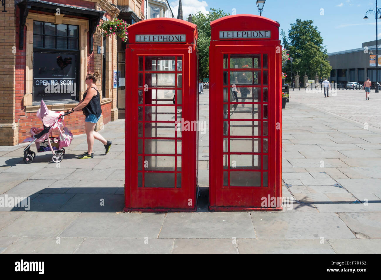 Two classic red British telephone boxes type K6 still in use in Darlington Market Place Durham England. Stock Photo