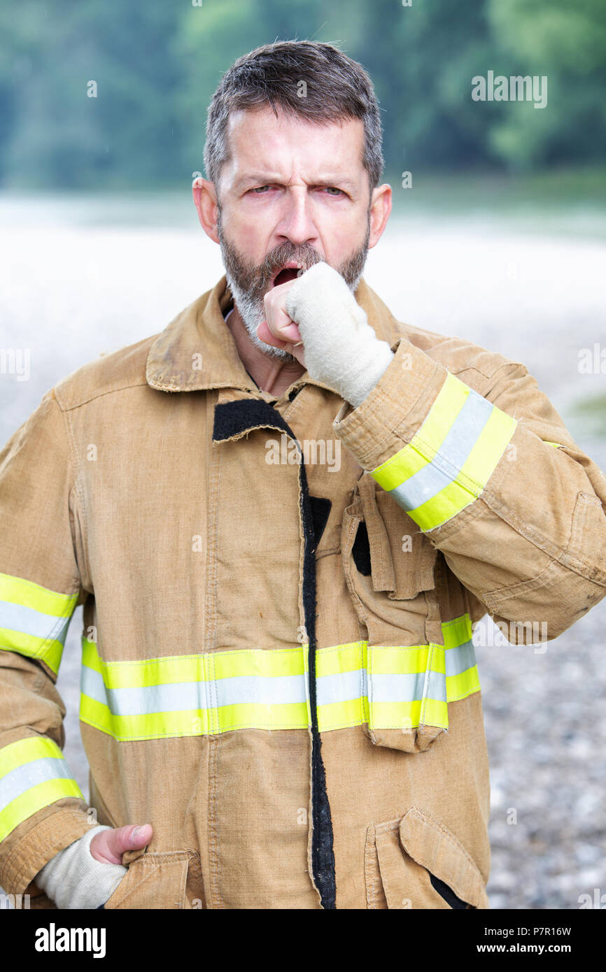 portrait of handsome Blue Collar man in work wear yawning Stock Photo