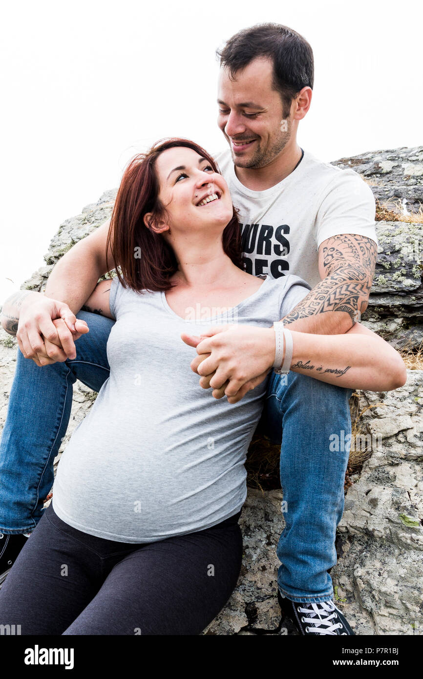 Young couple expecting a baby, outside on mountain Stock Photo