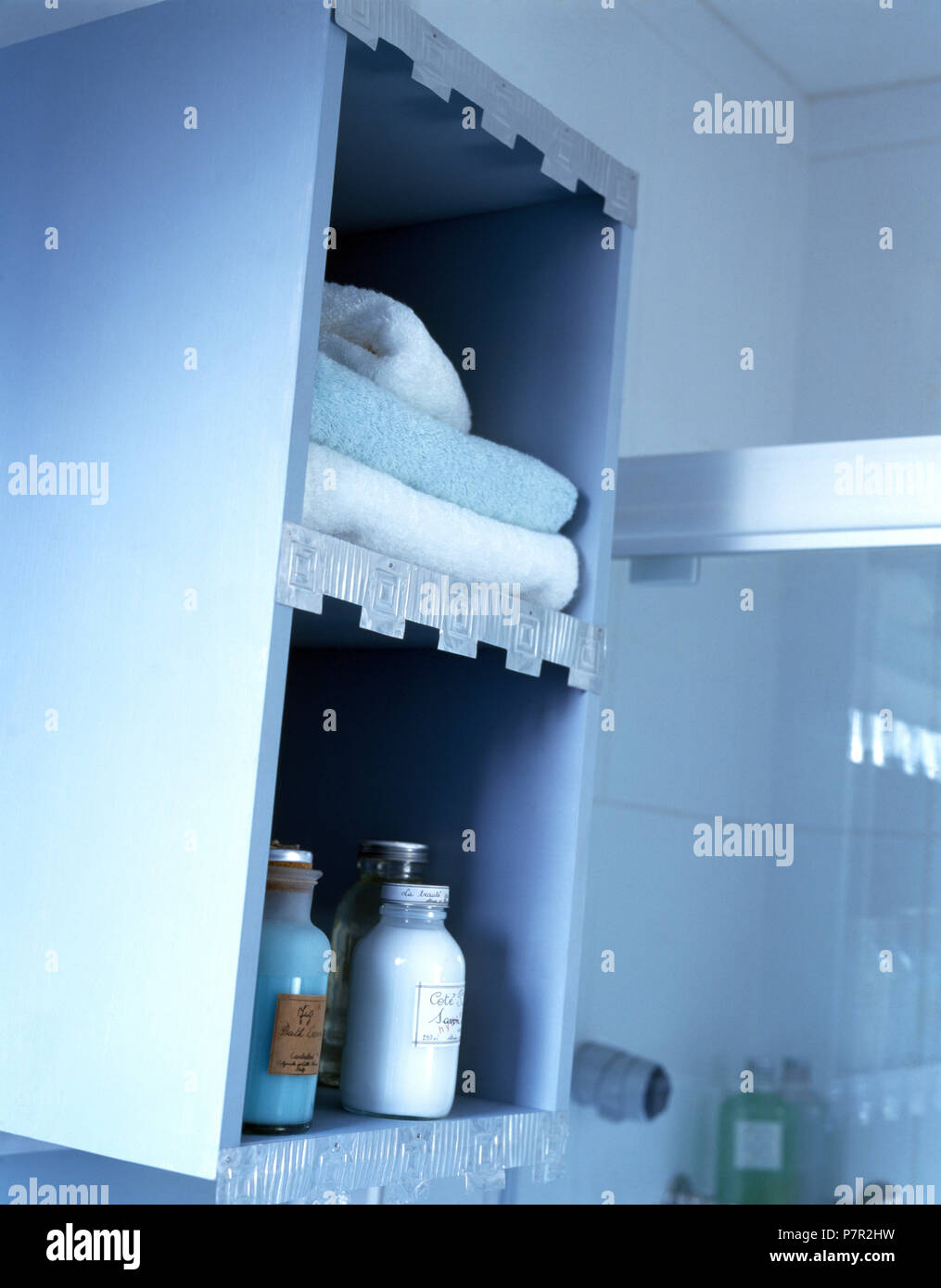 Folded towels and bottles of toiletries on painted and renovated blue