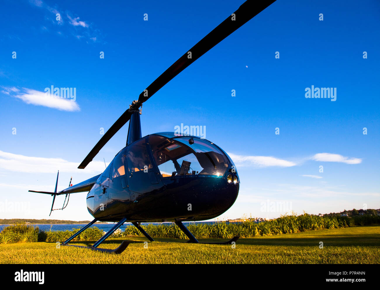 Robinson R-44 ready for takeoff in late afternoon Stock Photo
