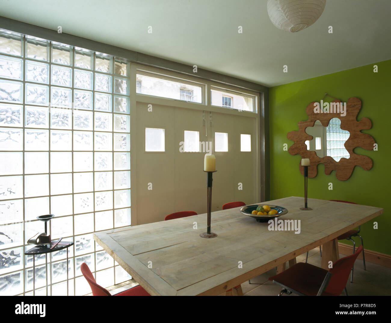 Plain Wood Table In Green Nineties Dining Room With Glass Brick Wall