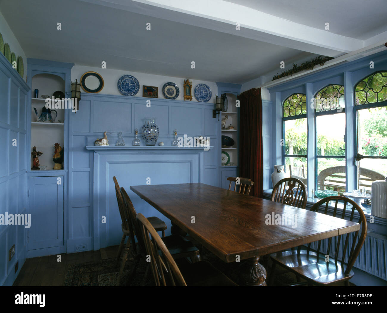 Windsor chairs at oak table in pale blue dining room Stock Photo Alamy