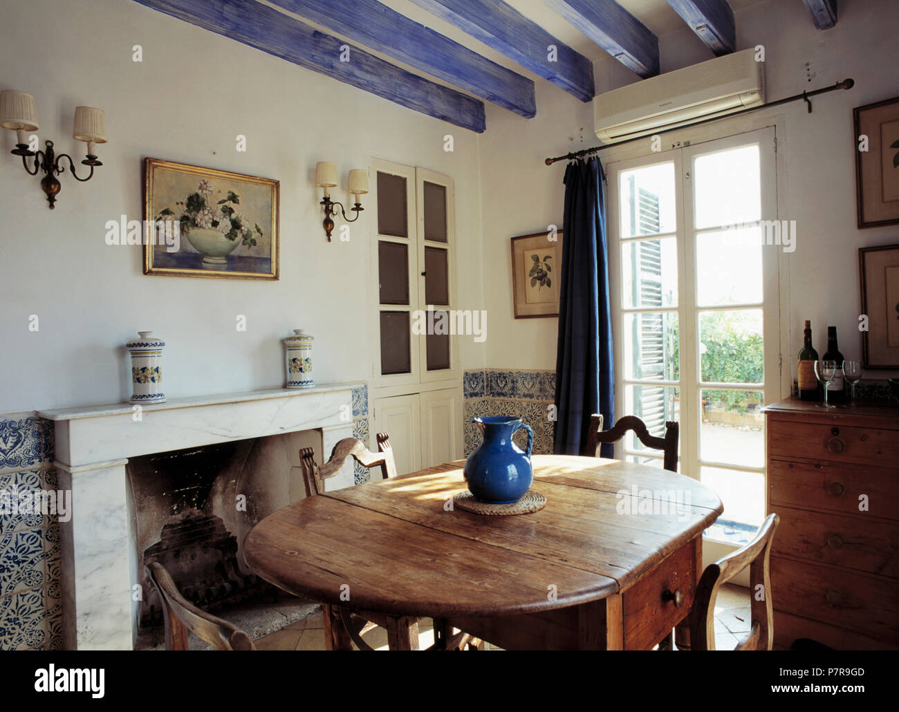 Painted Blue Ceiling Beams In Mediterranean Dining Room With