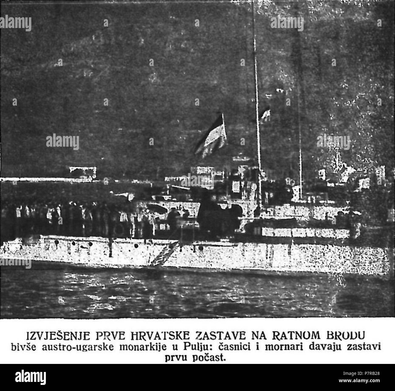 English: First Croatian flag ever hoisted on a naval ship, Pula, October 31st, 1918, with the crews saluting the flag. The ships were previously in service with Austro-Hungarian Navy. The entire fleet was ordered by the emperor Charles I to be transferred to fledgling Croatian authorities during the breakup of Austria-Hungary at the end of WWI. 16 September 2016, 18:20:39 322 Prva hrvatska zastava 52 3 1919 dis Stock Photo