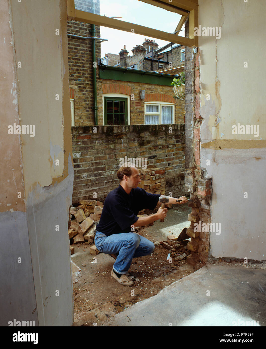 Man knocking out wall FOR EDITORIAL USE ONLY Stock Photo Alamy