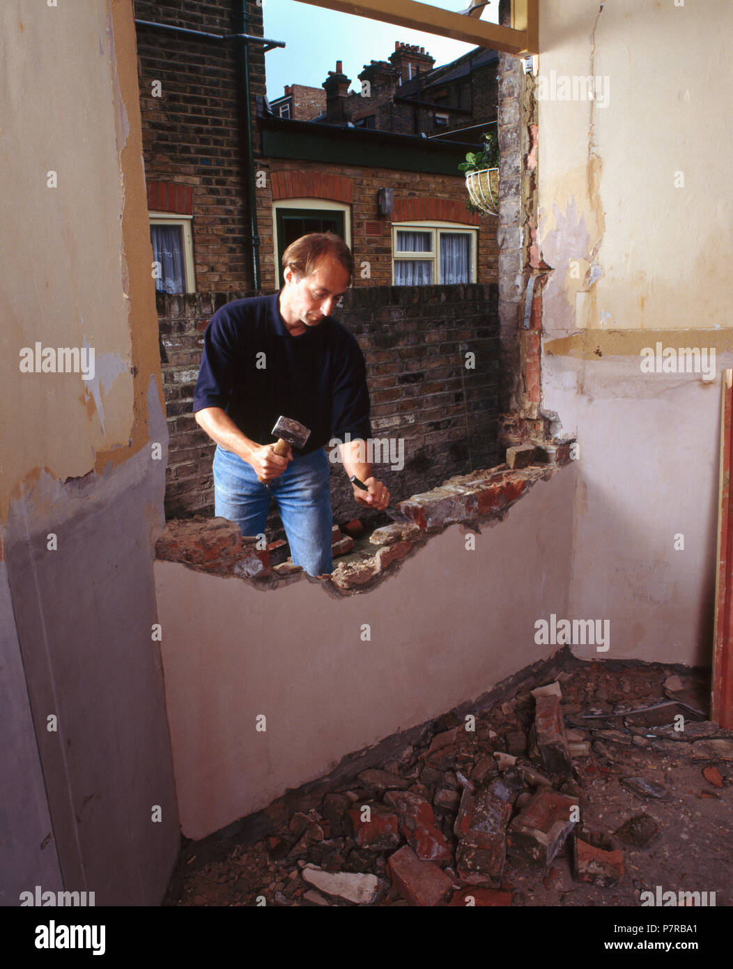 Man knocking out wall         FOR EDITORIAL USE ONLY Stock Photo