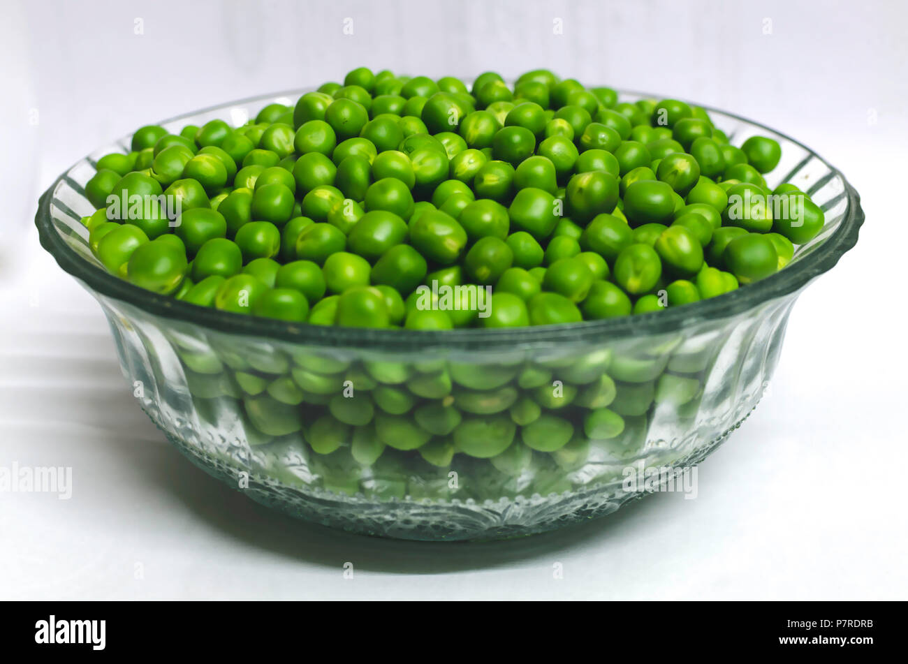 A glass bowl full of Green peas Stock Photo