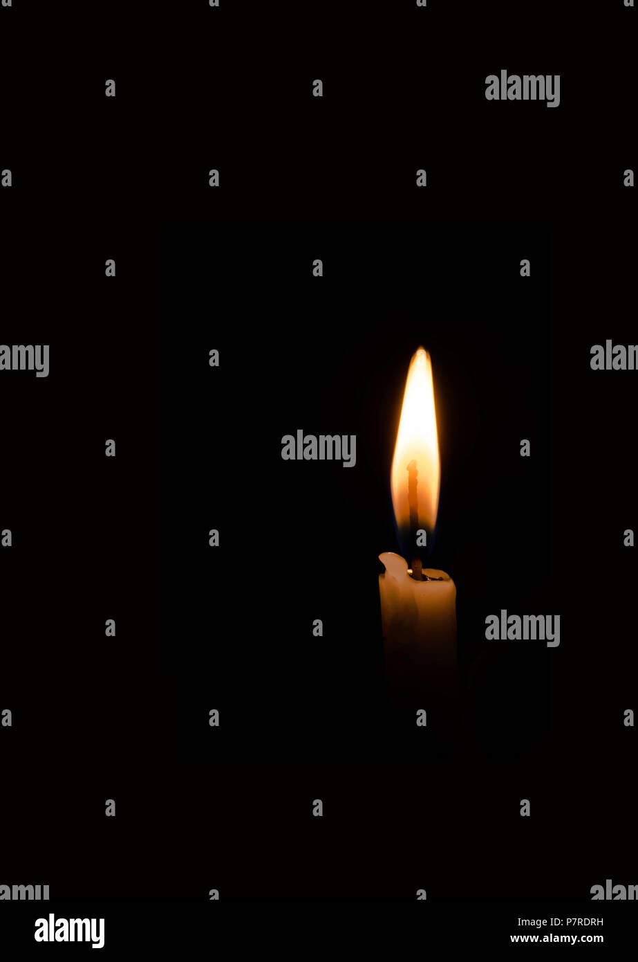 A burning candle in the dark room Stock Photo Alamy