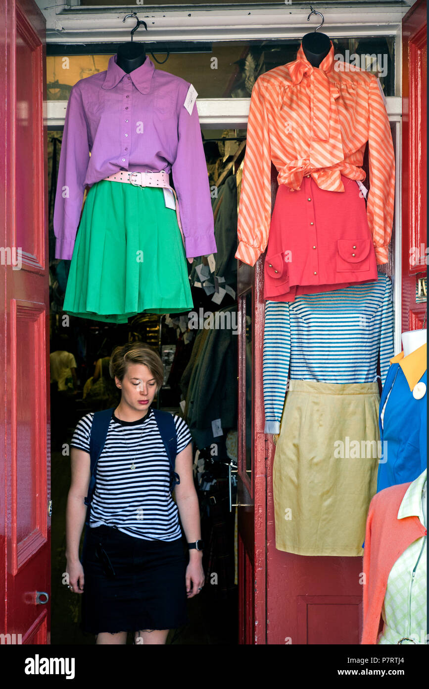 A customer leaving Armstrongs Vintage clothing emporium in the Grassmarket area of Edinburgh'd Old Town. Stock Photo
