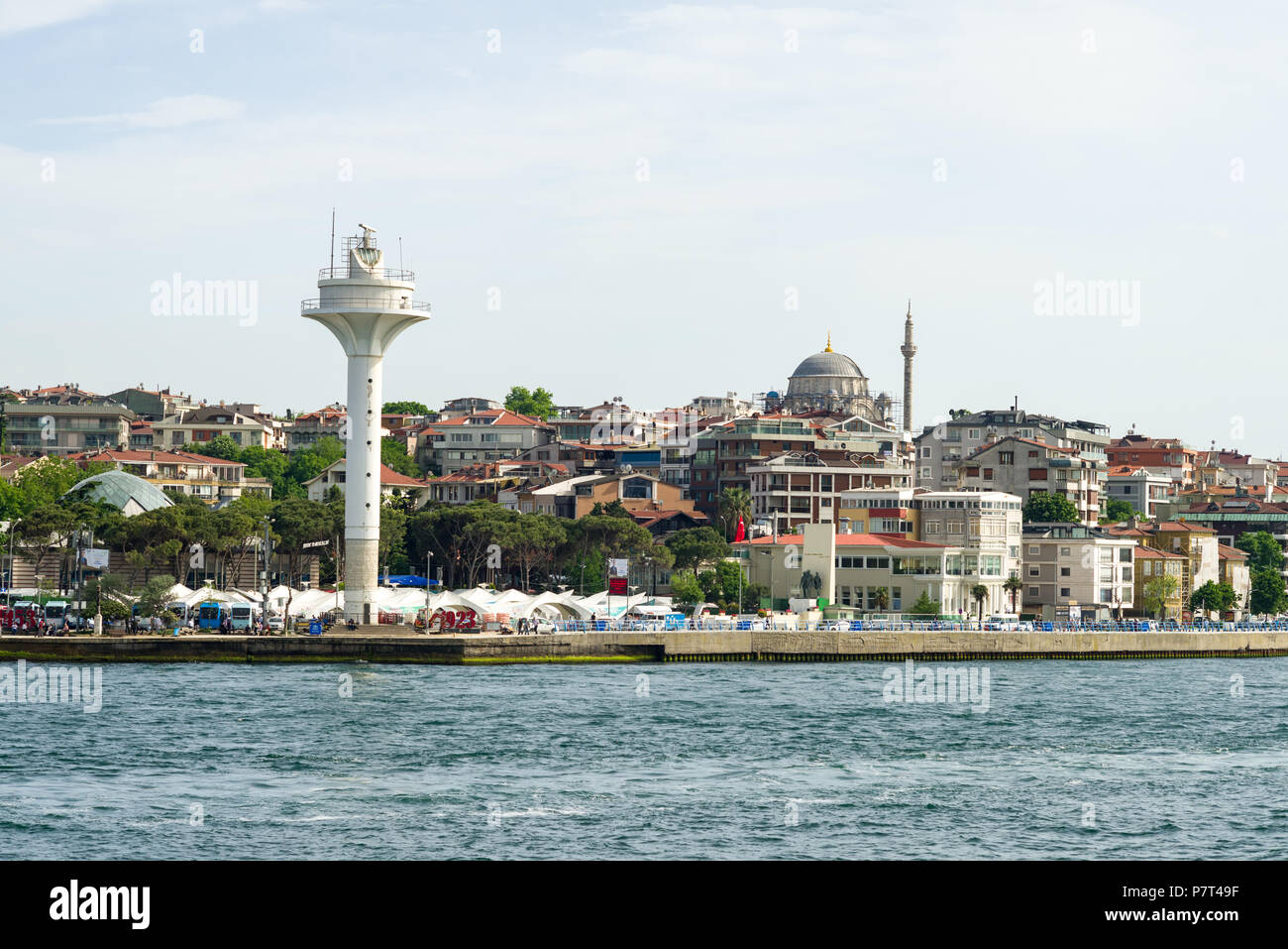 River traffic tower and buildings in the Üsküdar area of Istanbul from the Bosphorus Strait on a sunny day Stock Photo