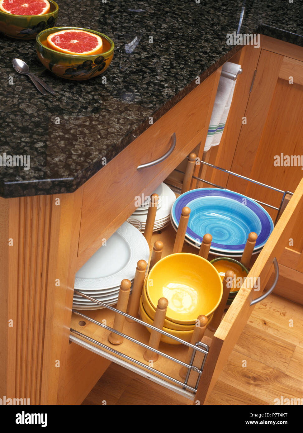 Kitchen unit with open drawer storing plates and bowls Stock Photo Alamy