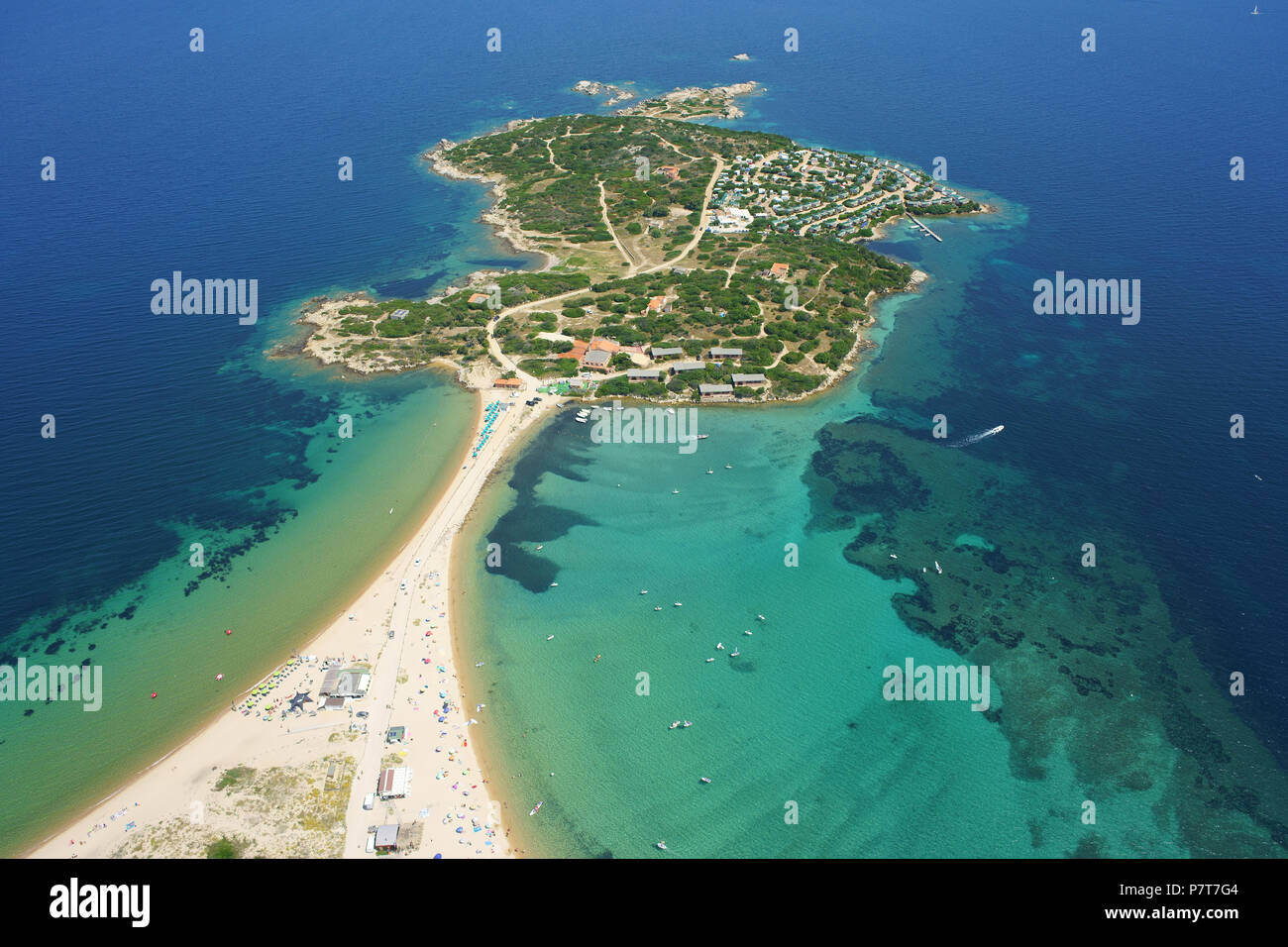 AERIAL VIEW. Small island with a narrow sandy isthmus linking to the  mainland. Isola dei Gabbiani, Porto Pollo, Province of Sassari, Sardinia, Italy. Stock Photo