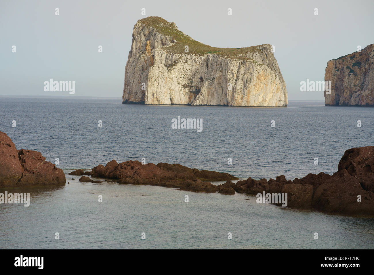 Large, lofty (elevation: 133 meters) monolith entirely surrounded by the sea. Pan di Zucchero, Nebida, Province of South Sardinia, Sardinia, Italy. Stock Photo