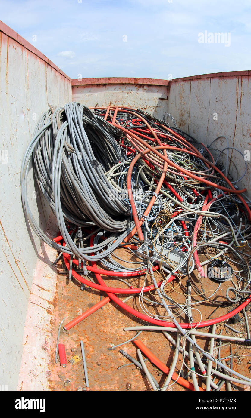 broken red and black electric cables in a large gray container Stock ...