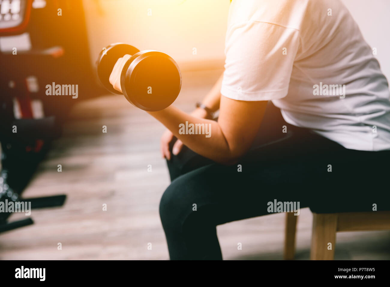 lady personal weight training biceps in sport club vintage color tone Stock Photo