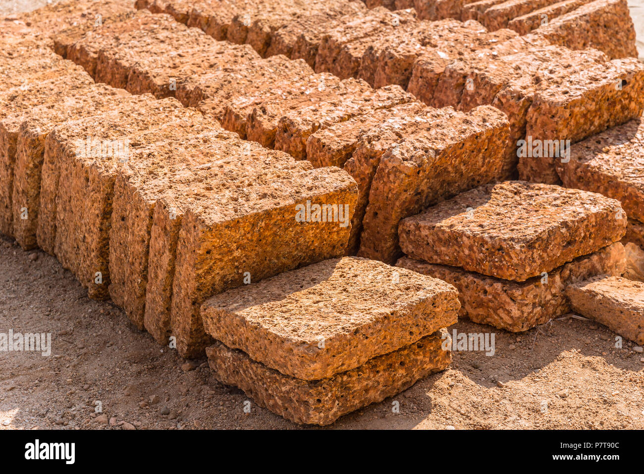 Laterite rock stone bricks plate from nature reddish rusty red color from rich in iron oxide Stock Photo
