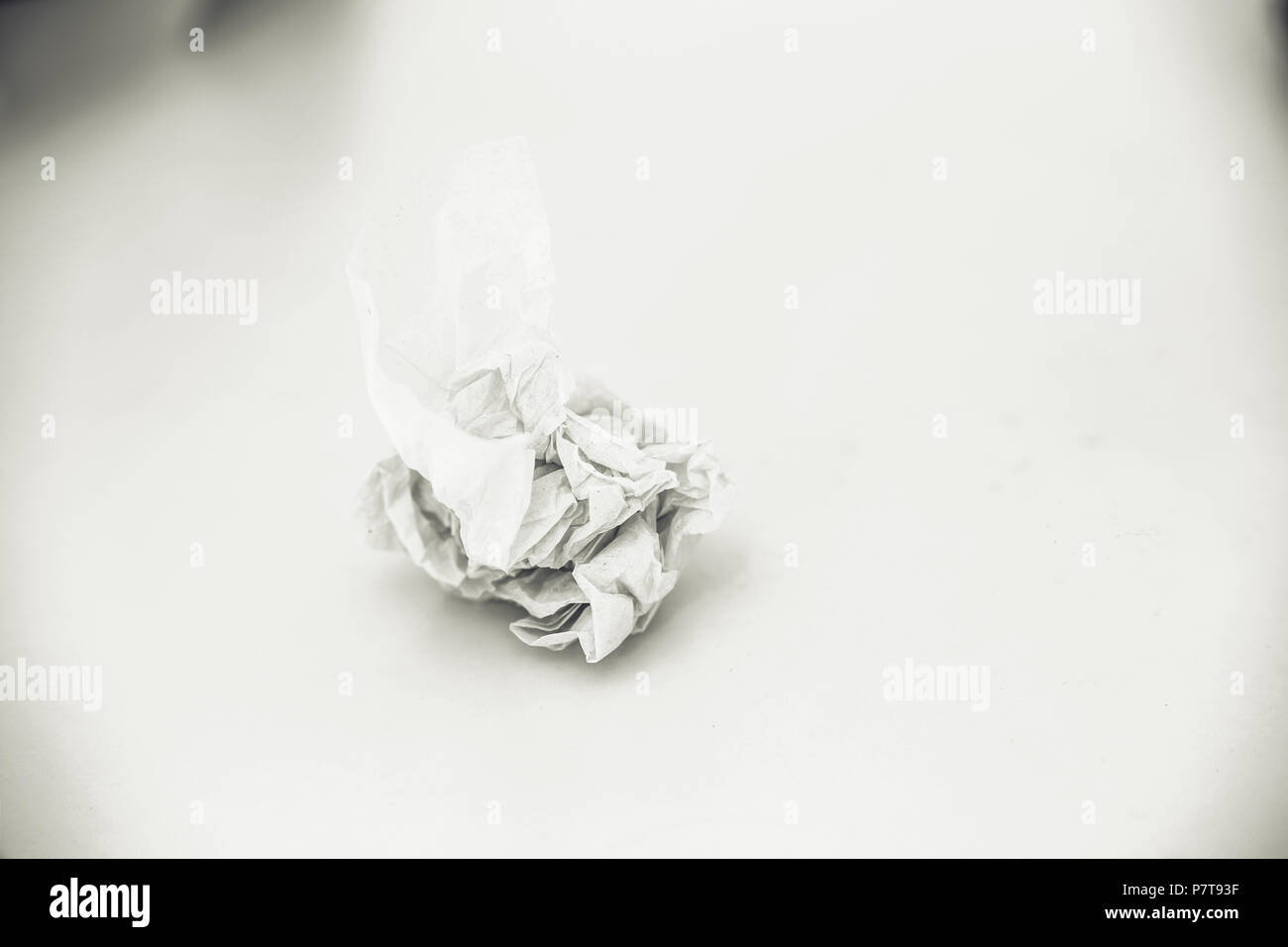 Crumpled paper on white table background Stock Photo