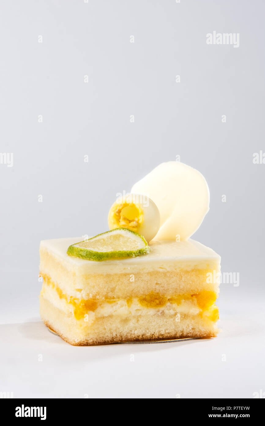 Lemon cake decorated with lime slice on white background Stock Photo
