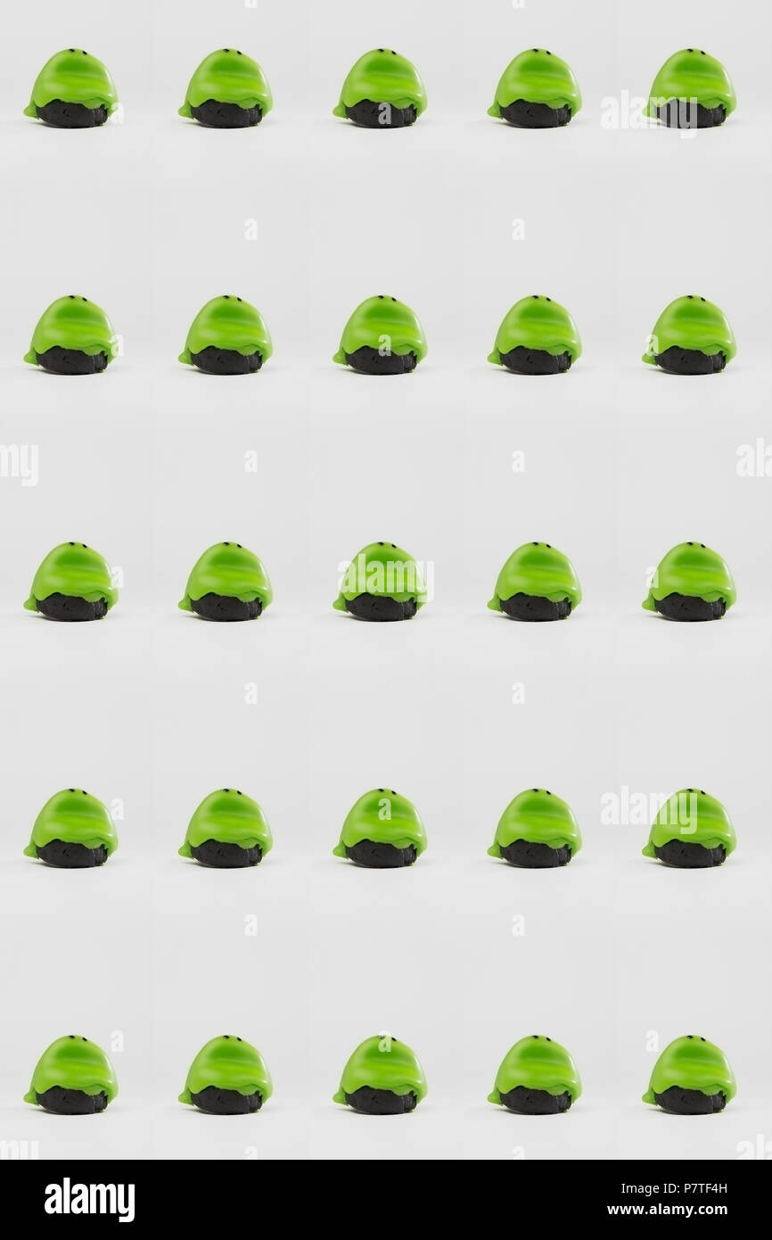 Repetitive design with frog-shaped cakes on white background Stock Photo