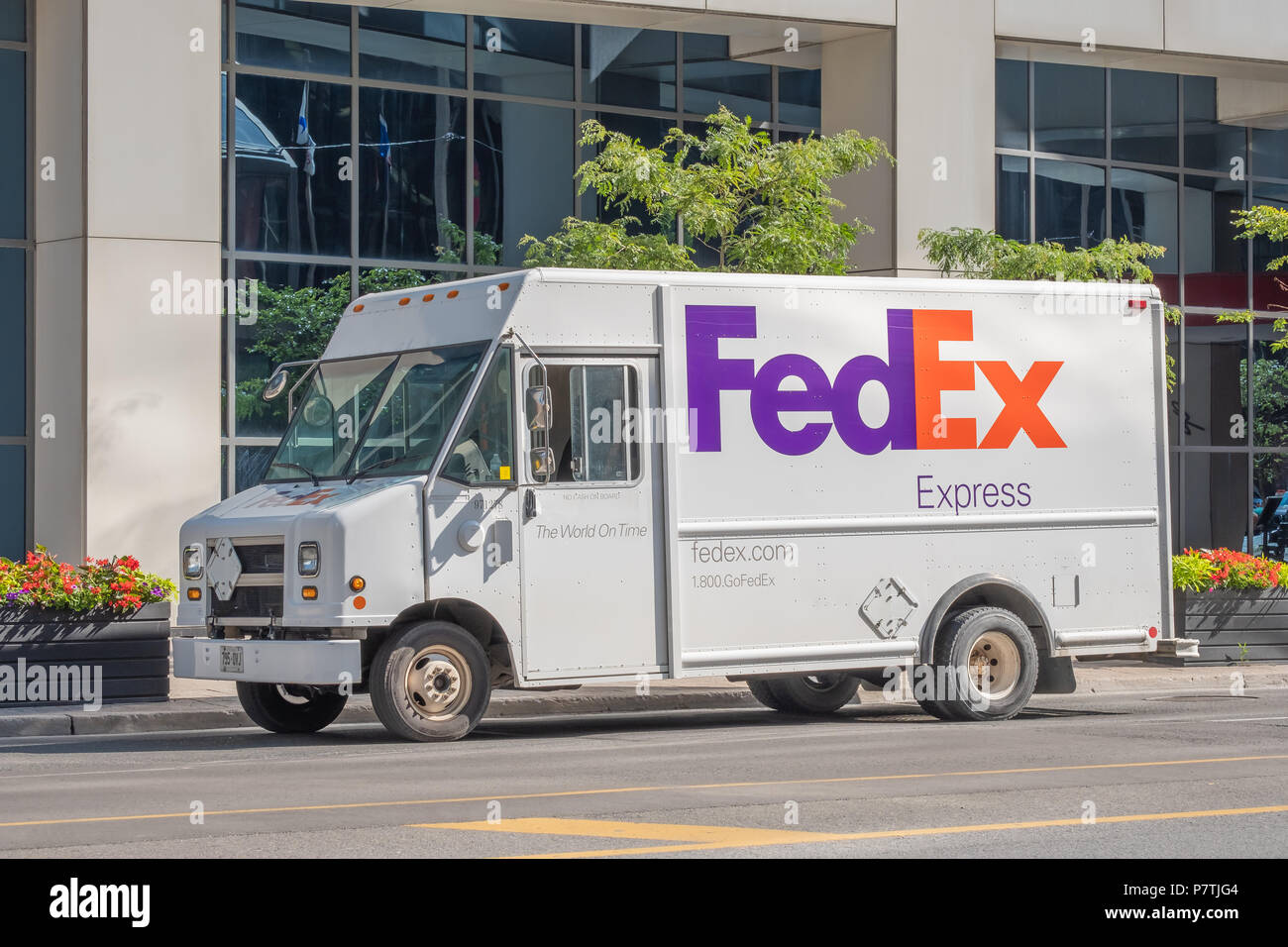 Federal Express delivery truck blocking a lane while making a delivery in downtown Toronto Ontario. Stock Photo