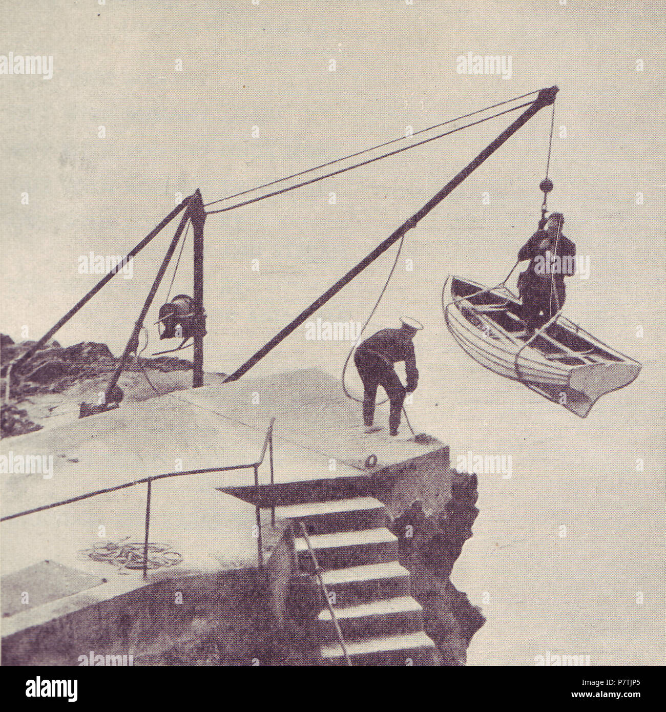 English: Photograph of a row-boat being hoisted onto an unidentified ...