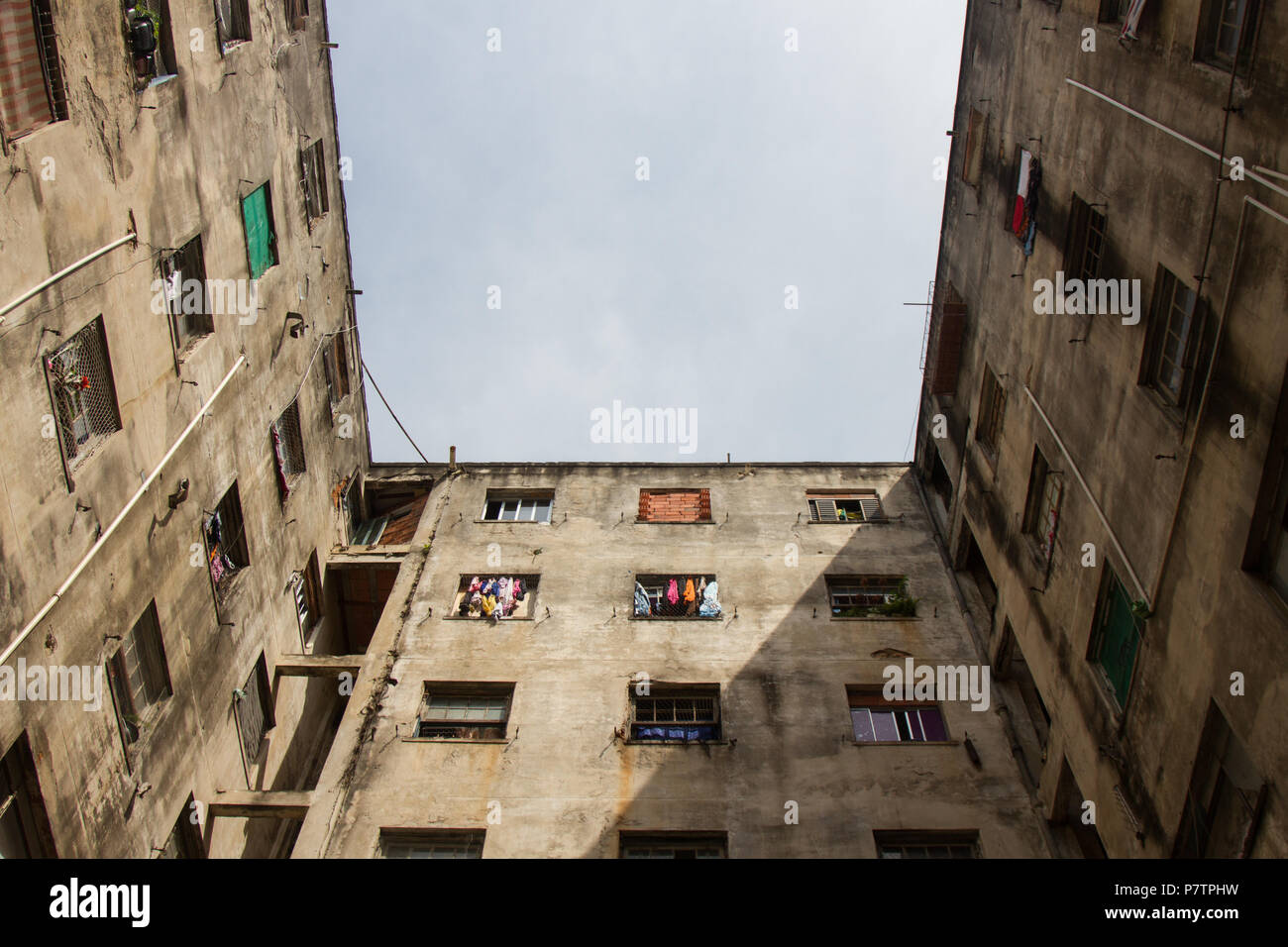 Worn building used as home by poor people Stock Photo - Alamy