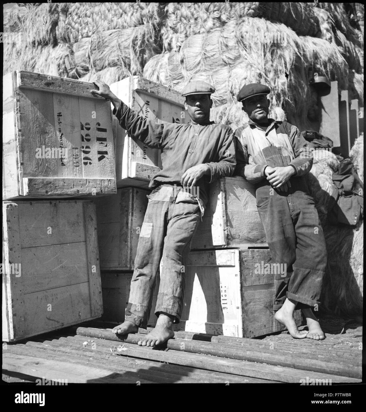 Portugal, Lissabon (Lisboa): Hafen; Zwei Männer vor Kisten mit der Aufschrift JFK, dahinter ein Berg Baumwolle. May 1941 78 CH-NB - Portugal, Lissabon (Lisboa)- Hafen - Annemarie Schwarzenbach - SLA-Schwarzenbach-A-5-24-092 Stock Photo
